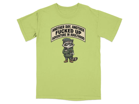 Green t-shirt with raccoon graphic and text "Another day, another fucked up adventure in adulthood".