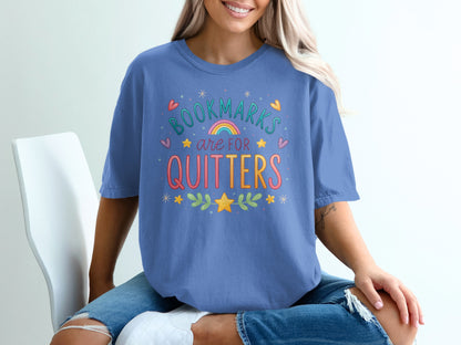 Blue t-shirt with "Bookmarks are for quitters" text and colorful decorations.
