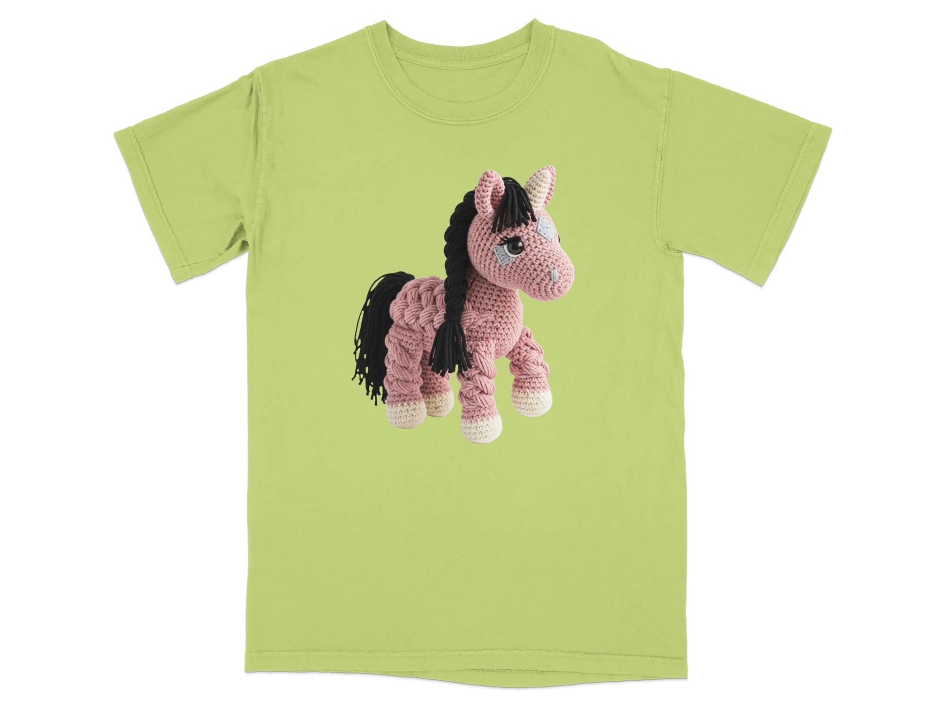 Crocheted unicorn with pink yarn, black mane, and white hooves on a light green t-shirt.