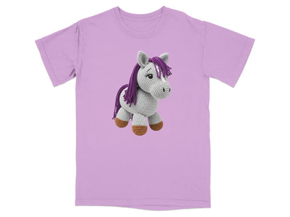 Crocheted unicorn with purple mane on a lilac t-shirt.