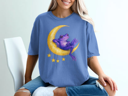 Purple frog sitting on a crescent moon with hanging stars.