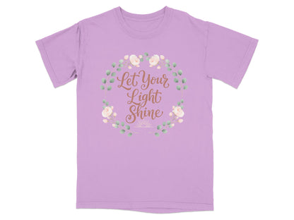 Purple t-shirt with "Let Your Light Shine" text and floral wreath.
