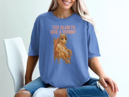 Woman wearing blue t-shirt with "Too Glam to Give a Whinny" graphic.