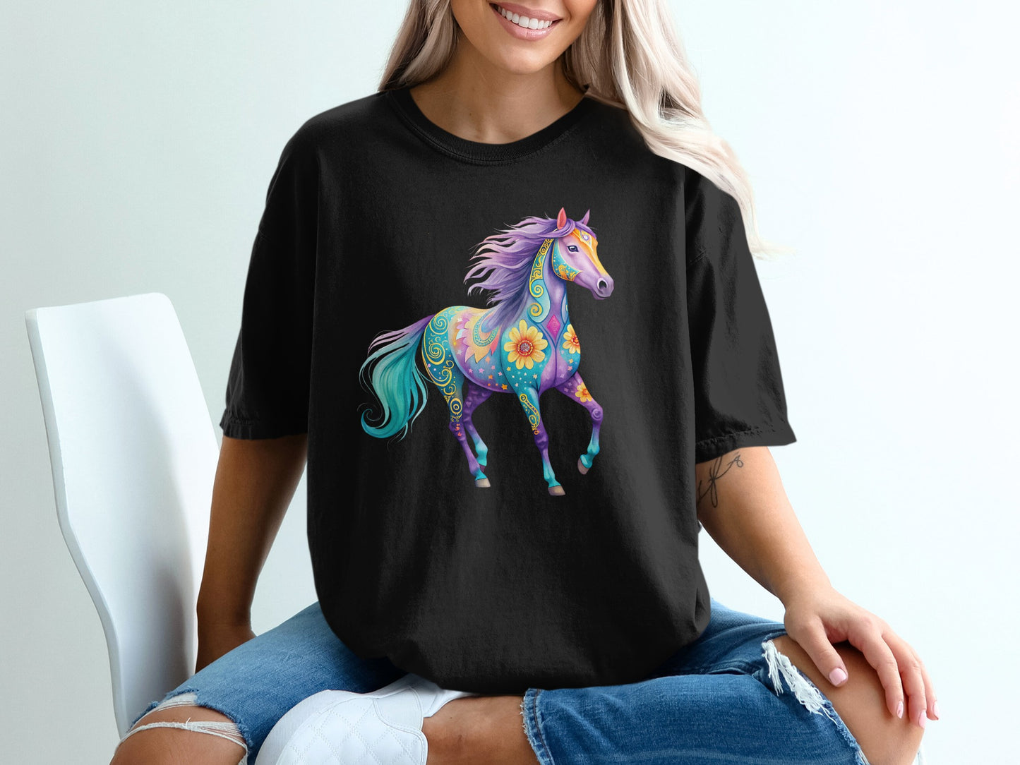 Black t-shirt featuring a colorful, abstract horse design with floral accents.