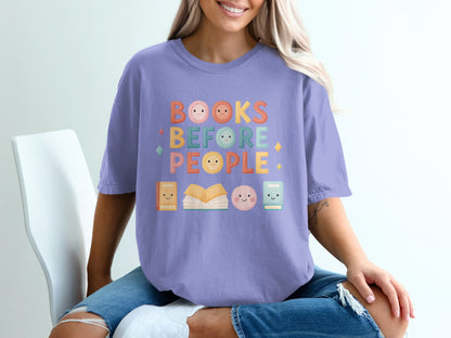 Purple t-shirt with "Books Before People" text and cute book and face icons.