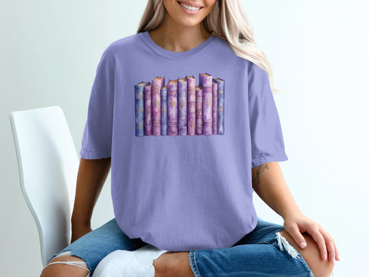 T-shirt with watercolor illustration of a stack of vintage books.