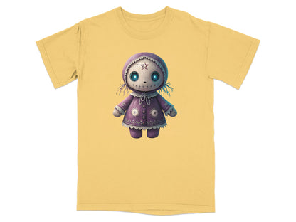 Purple doll graphic on a yellow t-shirt.