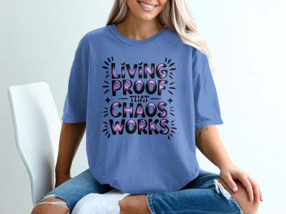 Periwinkle t-shirt with black text that reads "Living Proof That Chaos Works".