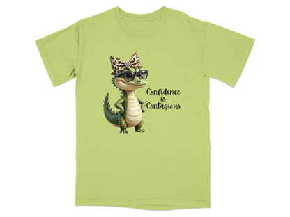 Green t-shirt with cartoon alligator wearing sunglasses and leopard print bow, "Confidence is Contagious" text.