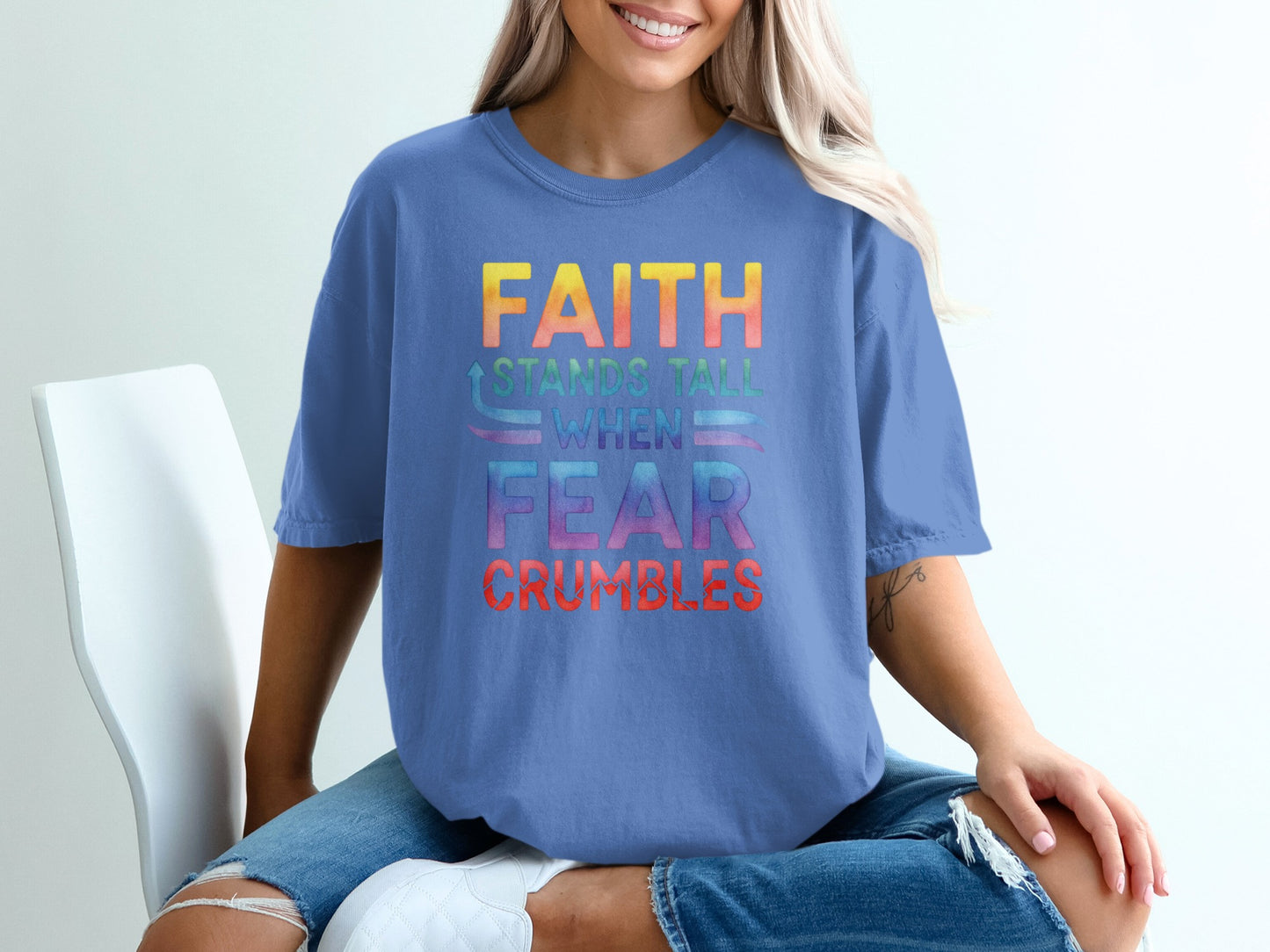 Blue t-shirt with "FAITH STANDS TALL WHEN FEAR CRUMBLES" text.