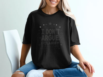 Black t-shirt with "I Don't Argue. I Clarify." text and stars.
