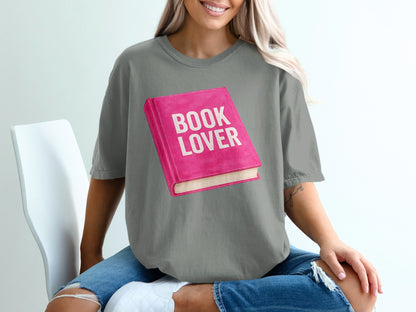 Pink book illustration with "BOOK LOVER" text on grey t-shirt.