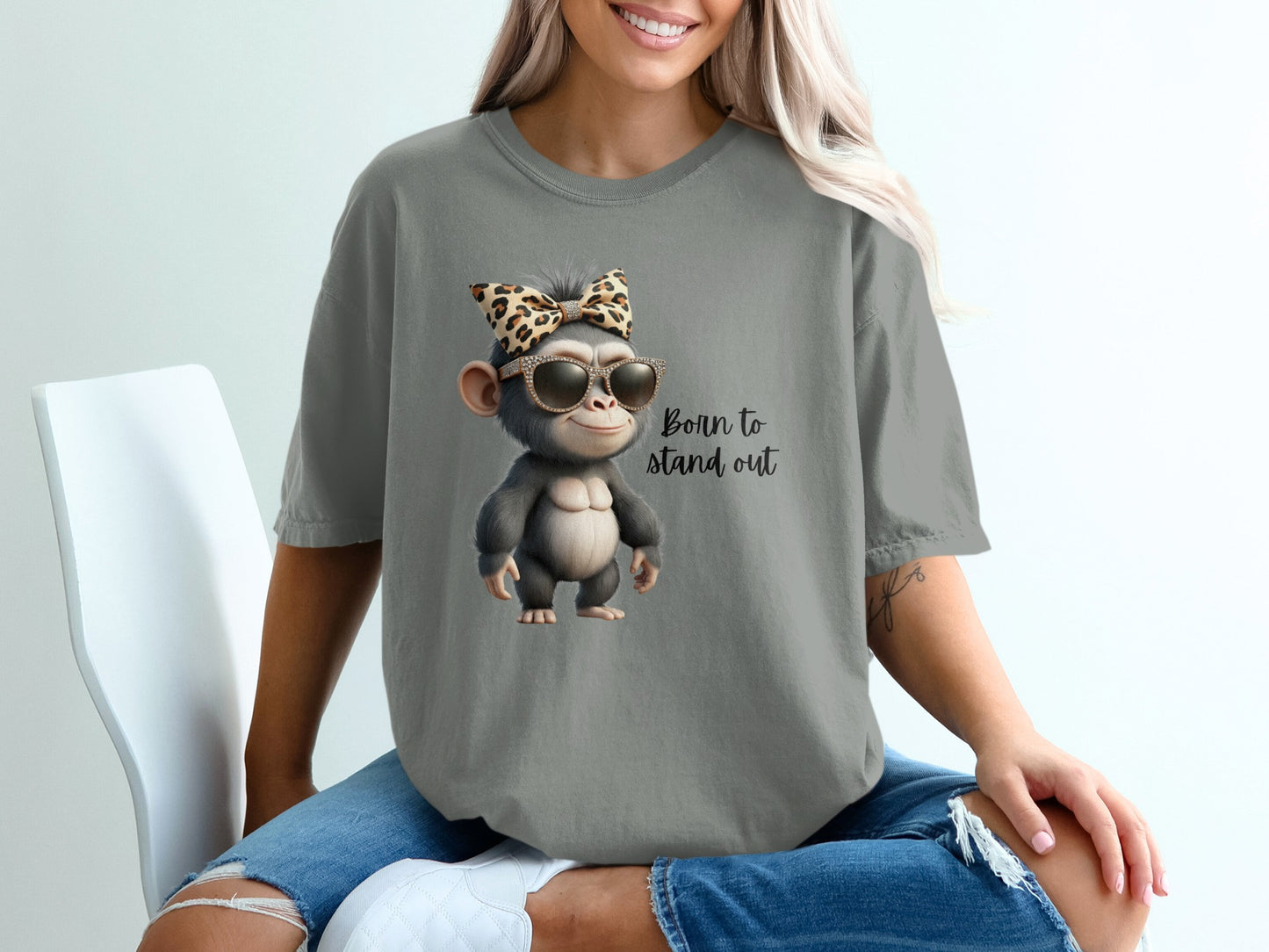 Cartoon monkey wearing sunglasses and leopard print bow, text "Born to stand out".
