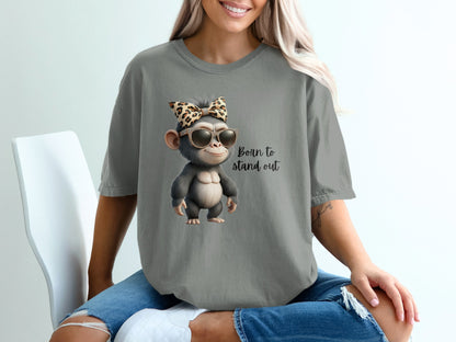 Cartoon monkey wearing sunglasses and leopard print bow, text "Born to stand out".