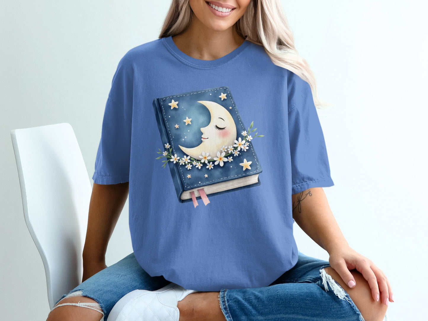 Blue t-shirt with sleeping moon and stars book graphic.