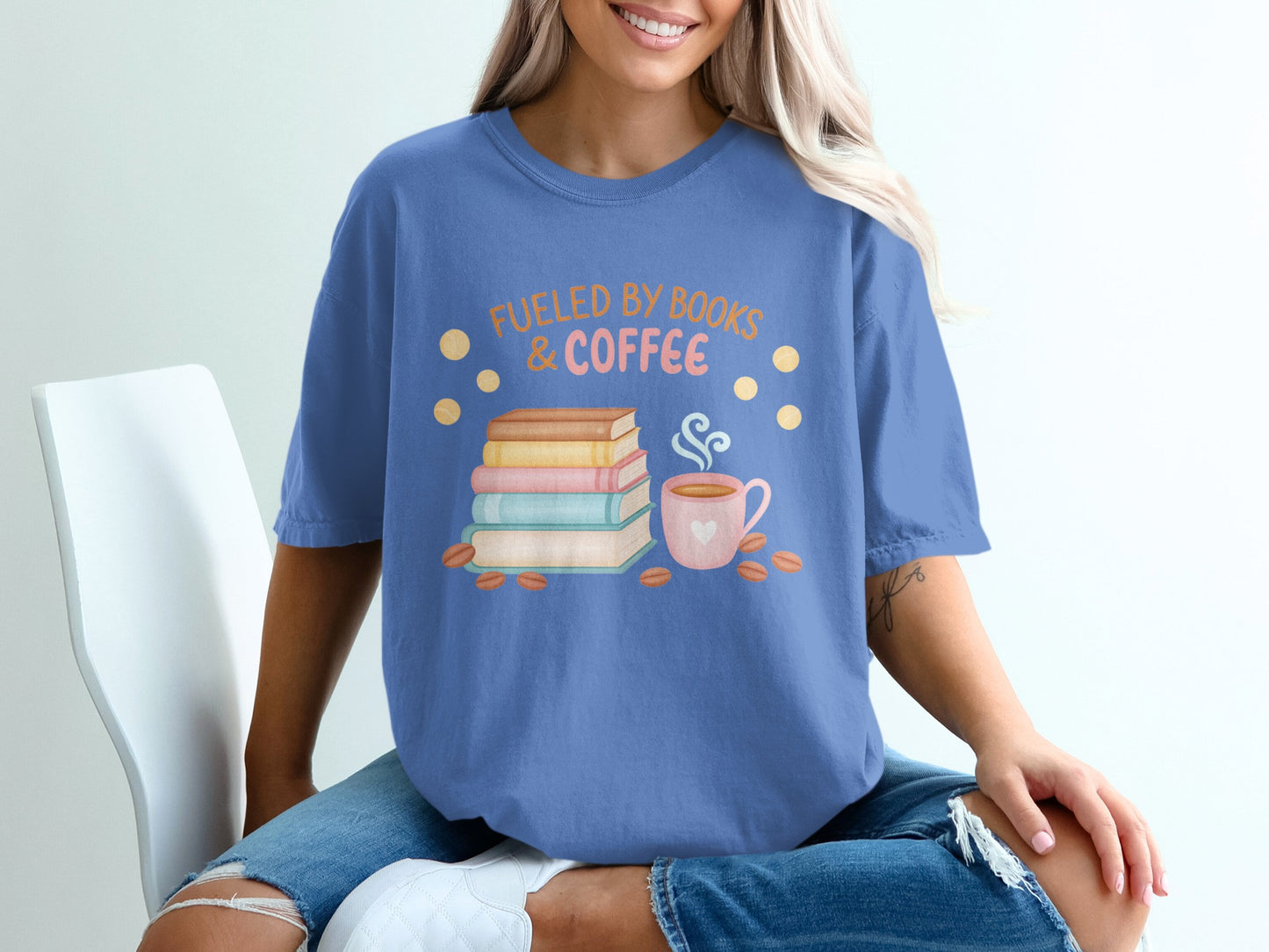 Blue t-shirt with "Fueled by Books & Coffee" text and stacked books graphic.