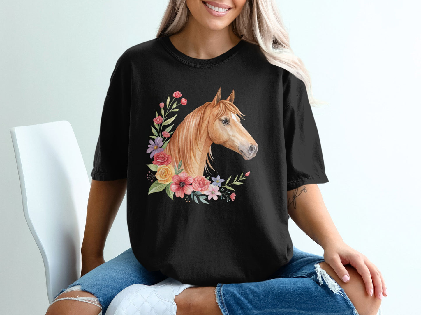 Black t-shirt with a horse head surrounded by flowers.