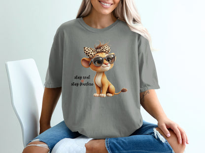 Cartoon lion cub wearing sunglasses and bow, with text "stay real stay fearless".