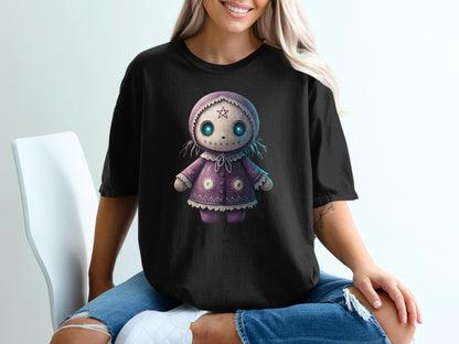 Black t-shirt with a purple cartoon doll graphic.