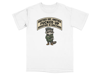 T-shirt with a raccoon wearing a hoodie and saying "Another day, another adventure in adulthood."
