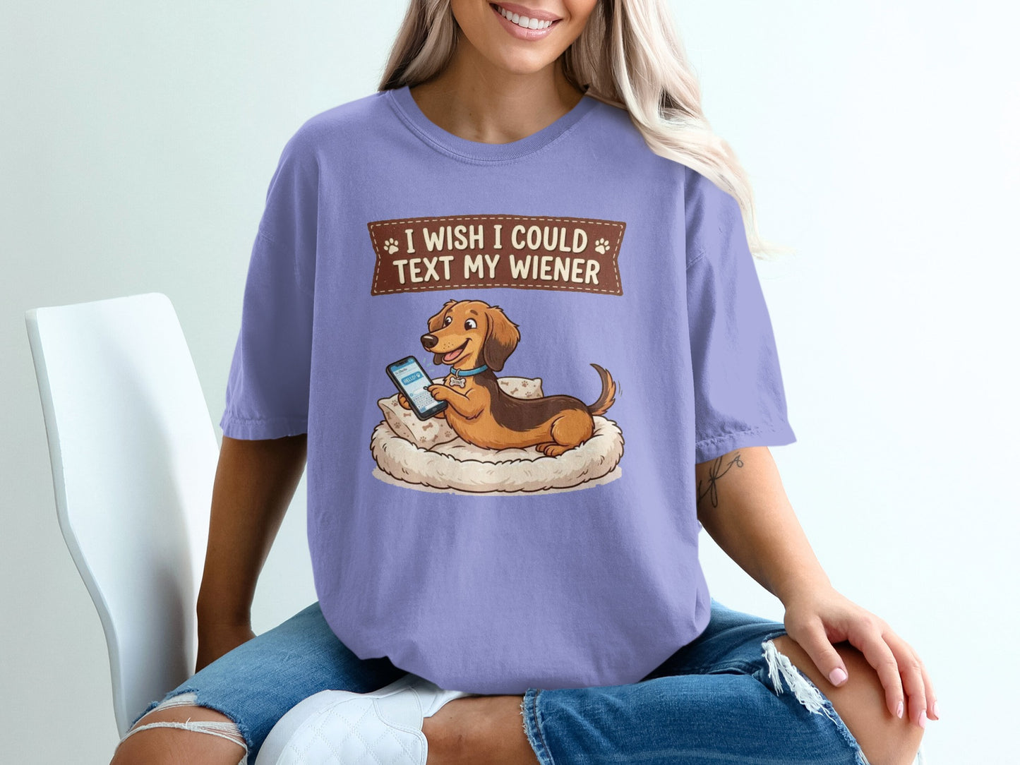 Dachshund dog wearing a collar rests on a cushion, text reads "I wish I could text my wiener".