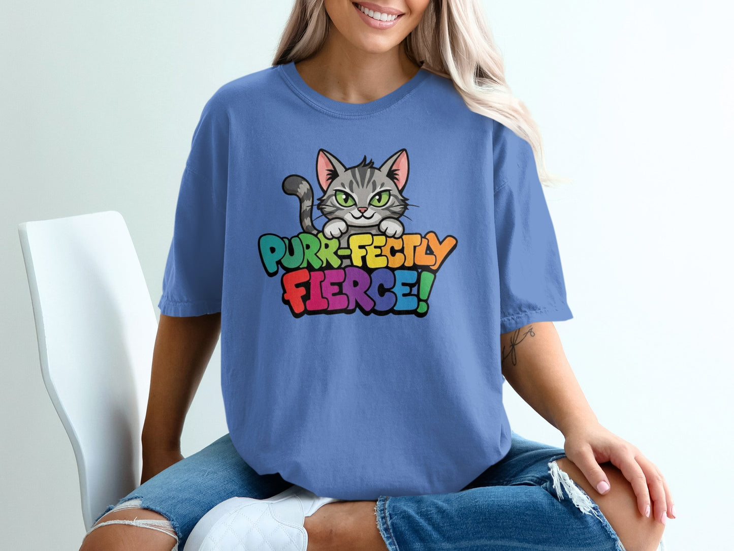 Blue t-shirt with "Purr-fectly Fierce!" in colorful text and a cat illustration.
