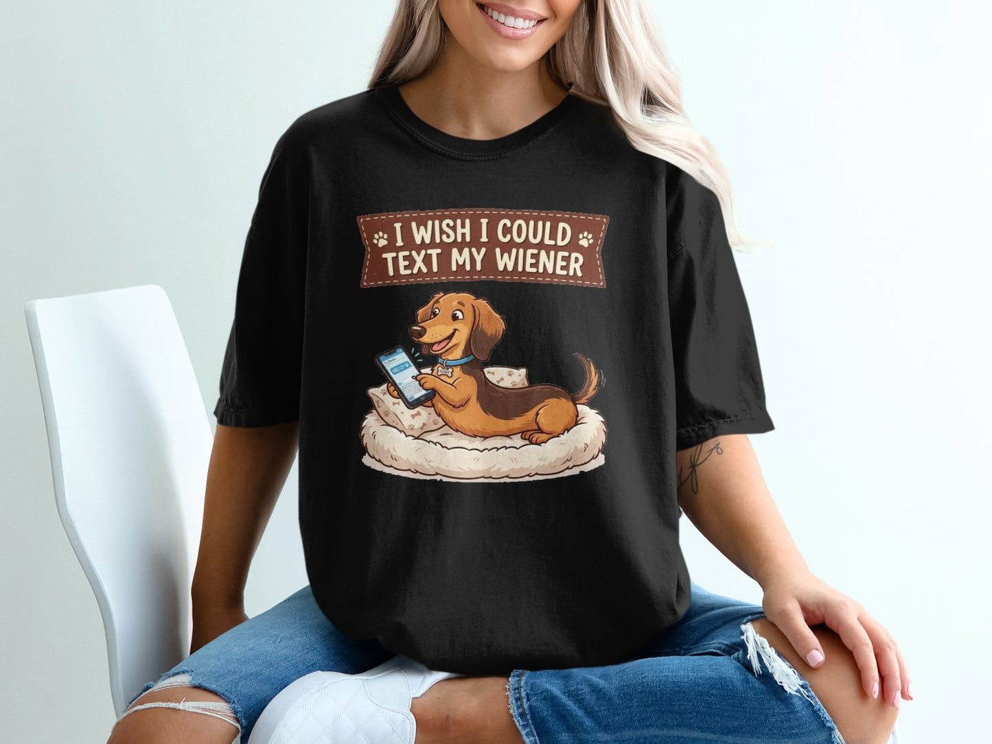 Black t-shirt with a dachshund text messaging on a pillow.