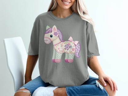 Gray t-shirt with a patchwork horse applique featuring floral and polka dot fabric.