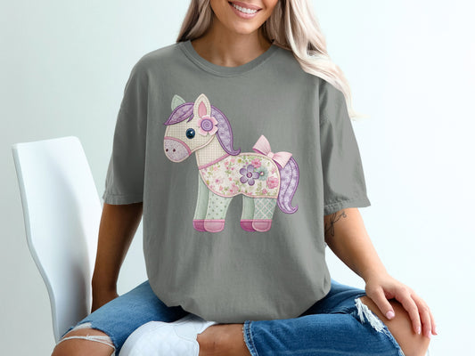 Gray t-shirt with a patchwork horse applique featuring floral and polka dot fabric.