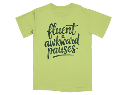 Light green t-shirt with "fluent in awkward pauses" text in black script.