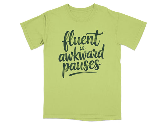 Light green t-shirt with "fluent in awkward pauses" text in black script.