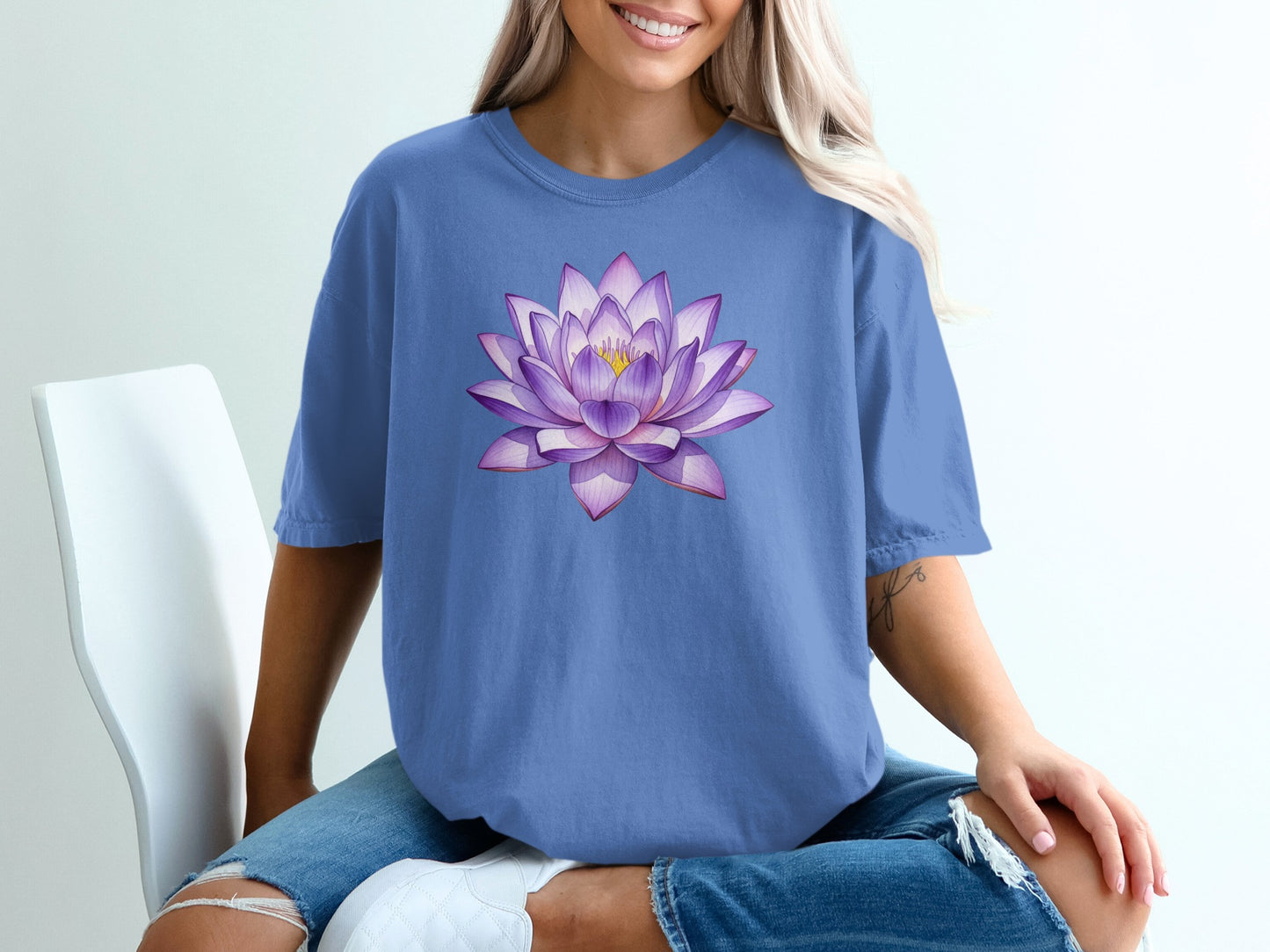 Blue t-shirt with a purple lotus flower graphic on the front.