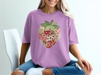 Purple t-shirt with a patchwork strawberry graphic.