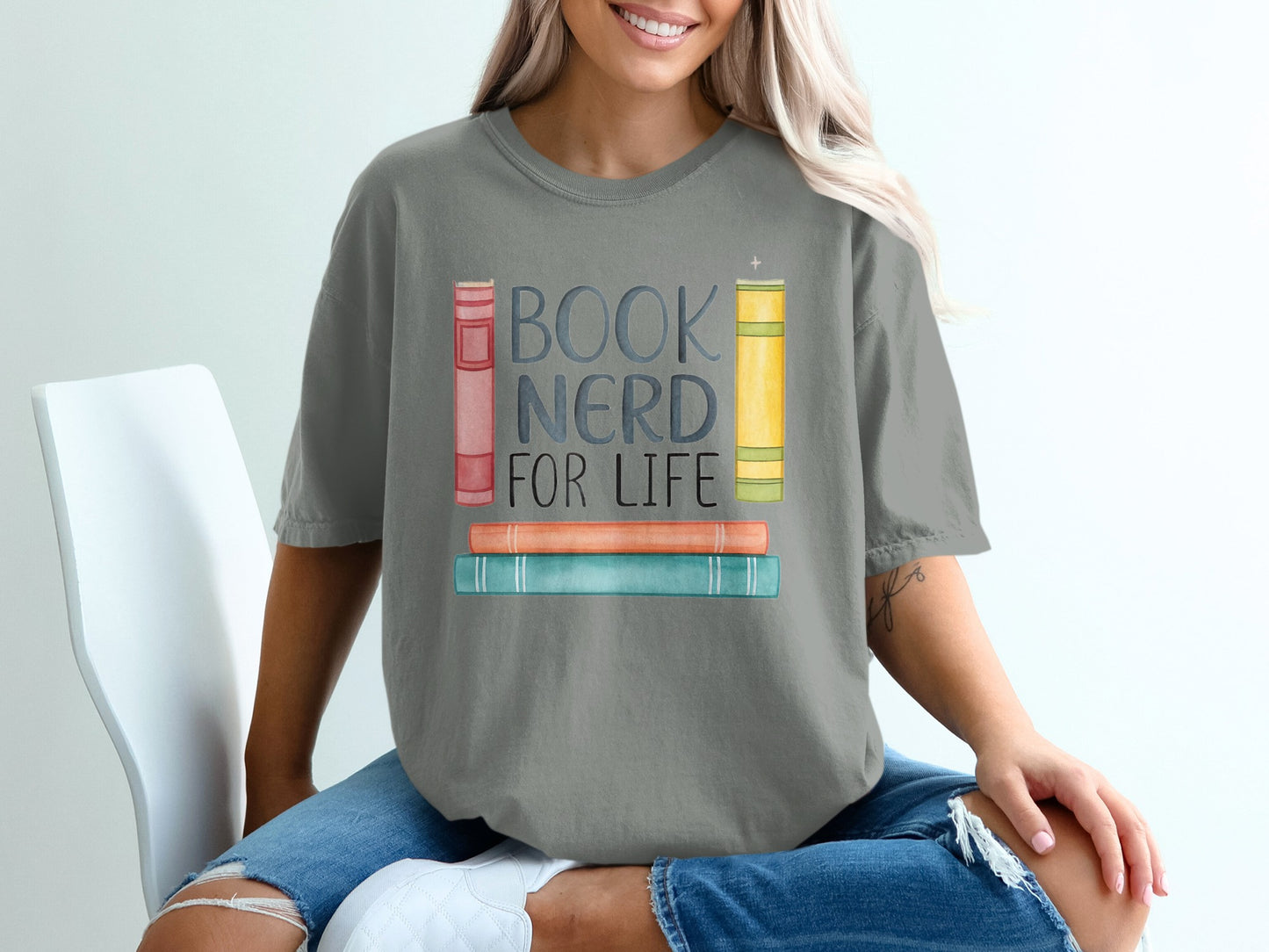 "Book Nerd for Life" text on t-shirt with watercolor books.