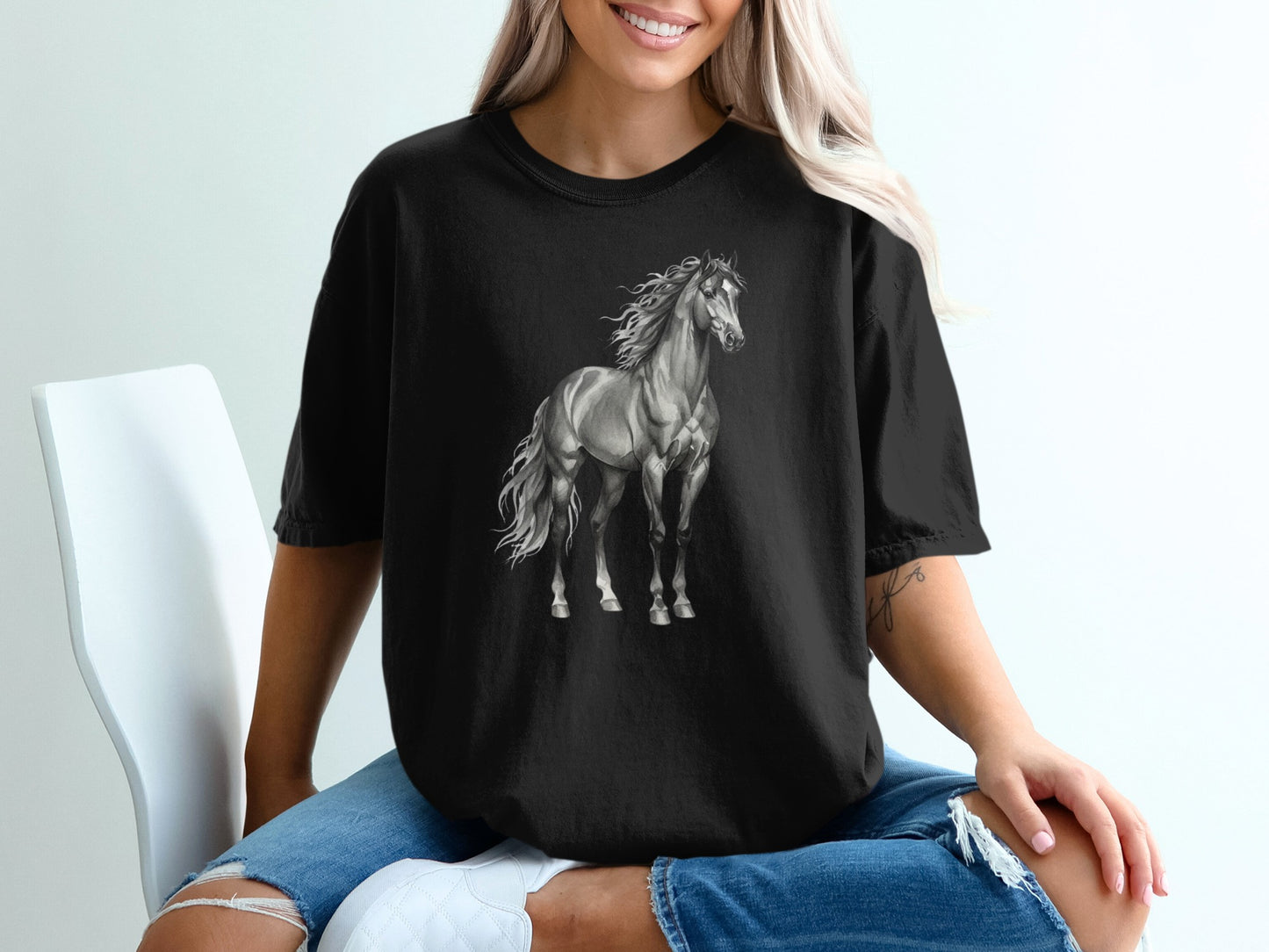 Black t-shirt with a grayscale drawing of a galloping horse.