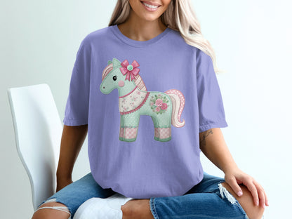 Purple t-shirt with a patchwork horse graphic and pink bow.