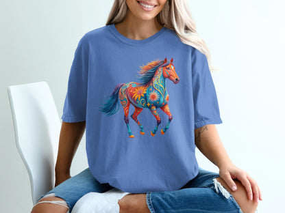 Blue t-shirt with a colorful, patterned horse graphic.