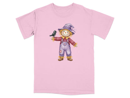 Pink t-shirt with a cartoon scarecrow wearing a hat and overalls, holding a bird.
