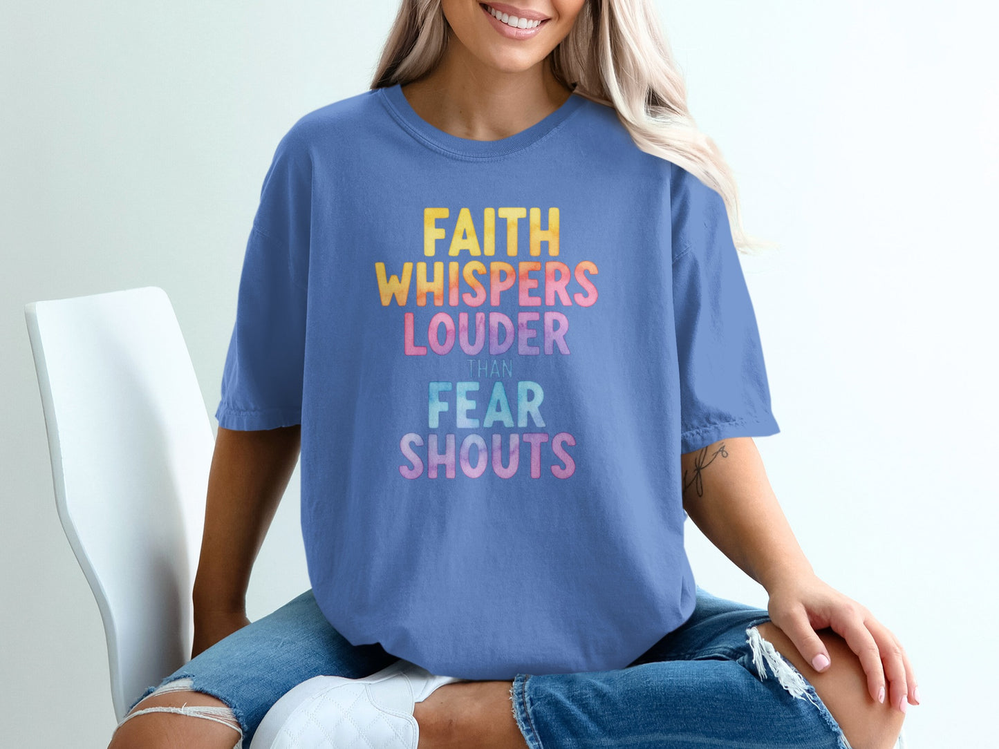 Blue t-shirt with "FAITH WHISPERS LOUDER THAN FEAR SHOUTS" text.