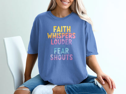 Blue t-shirt with "FAITH WHISPERS LOUDER THAN FEAR SHOUTS" text.