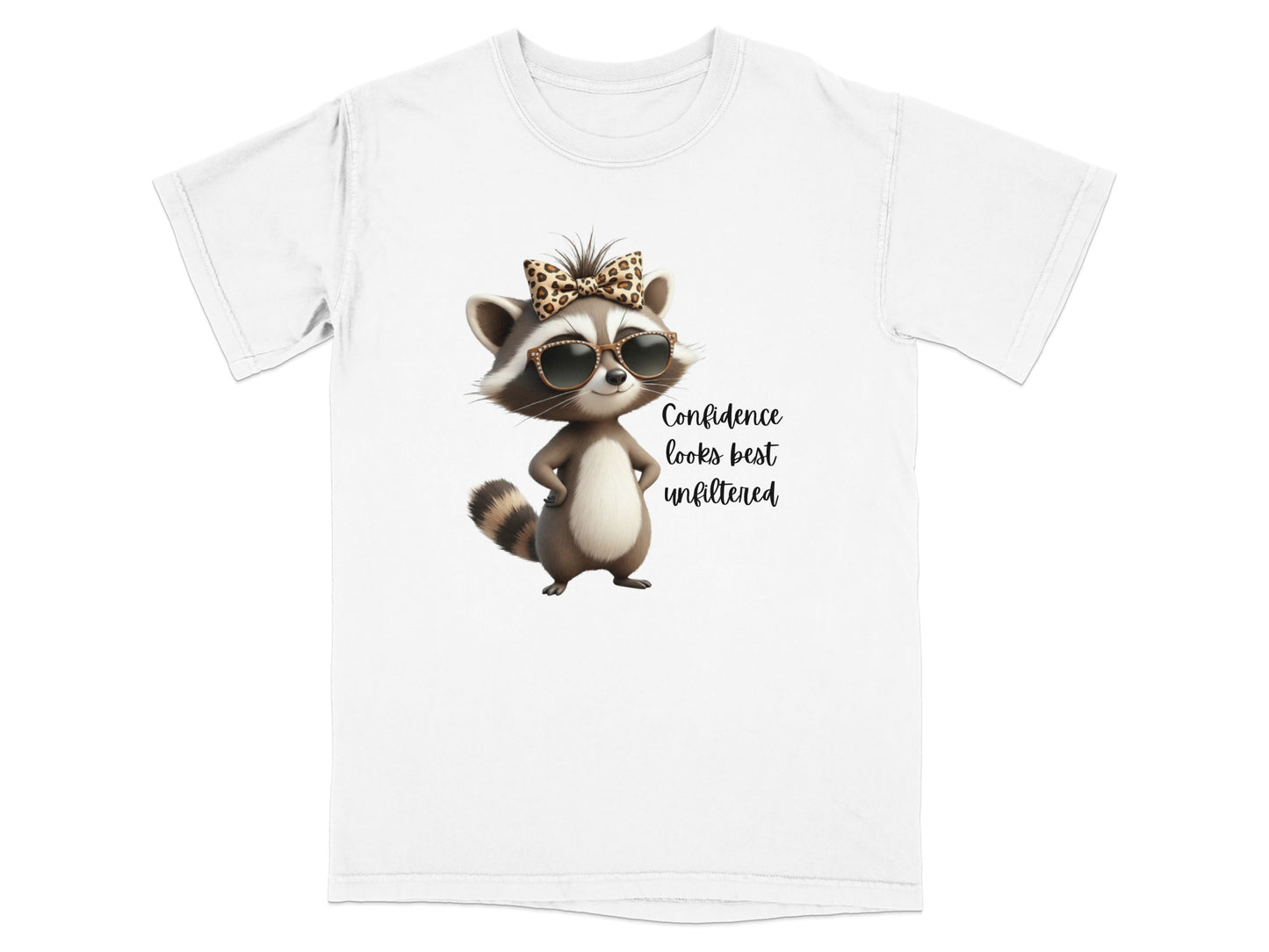 T-shirt with a cartoon raccoon wearing sunglasses and a bow, text reads "Confidence looks best unfiltered".