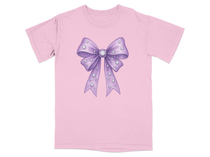 Purple watercolor bow with rhinestones on a pink t-shirt.