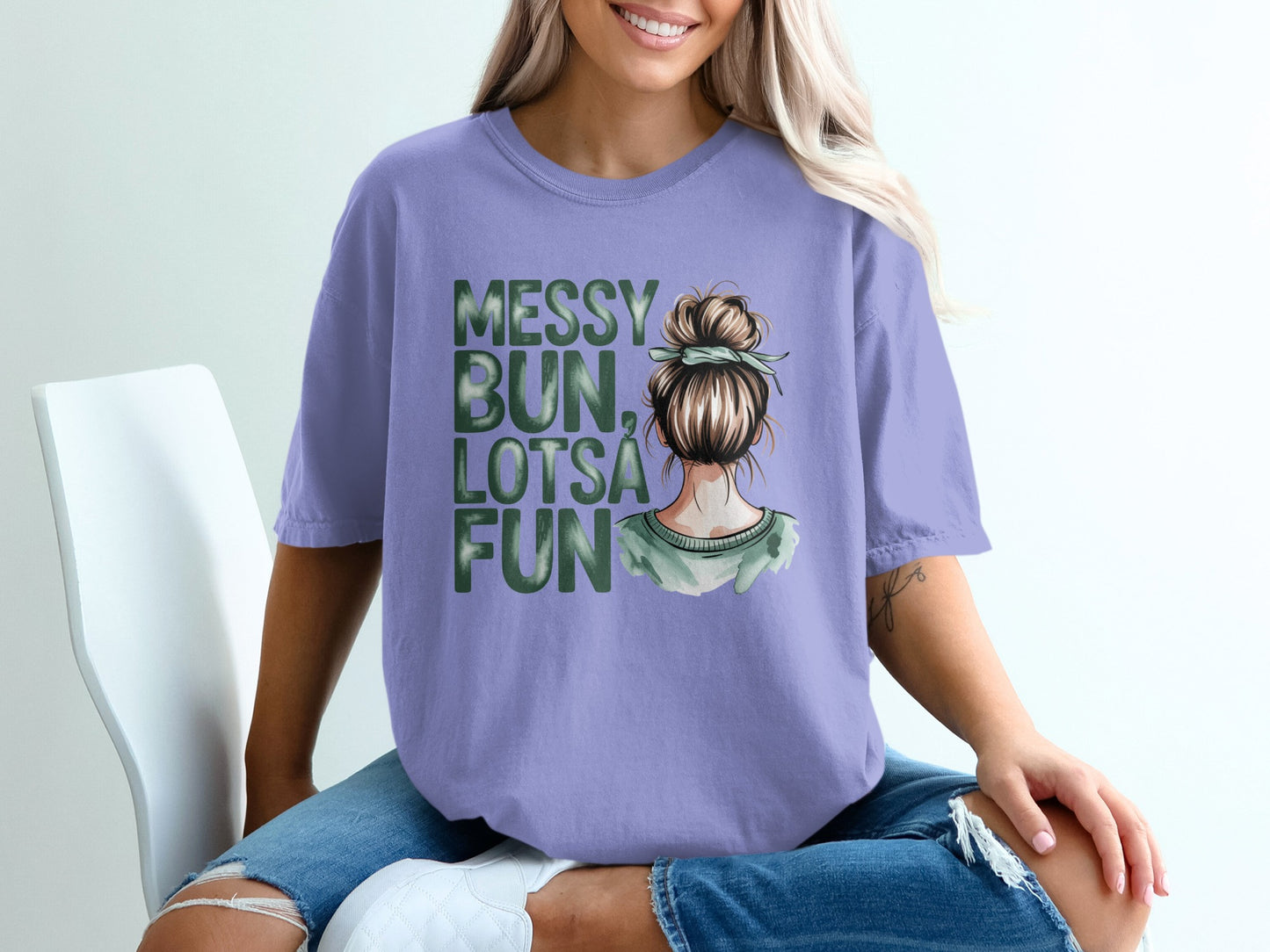 Purple t-shirt with "Messy Bun, Lotsa Fun" text and a watercolor illustration of a woman's head.