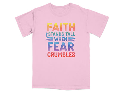 Pink t-shirt with rainbow text: "FAITH STANDS TALL WHEN FEAR CRUMBLES".