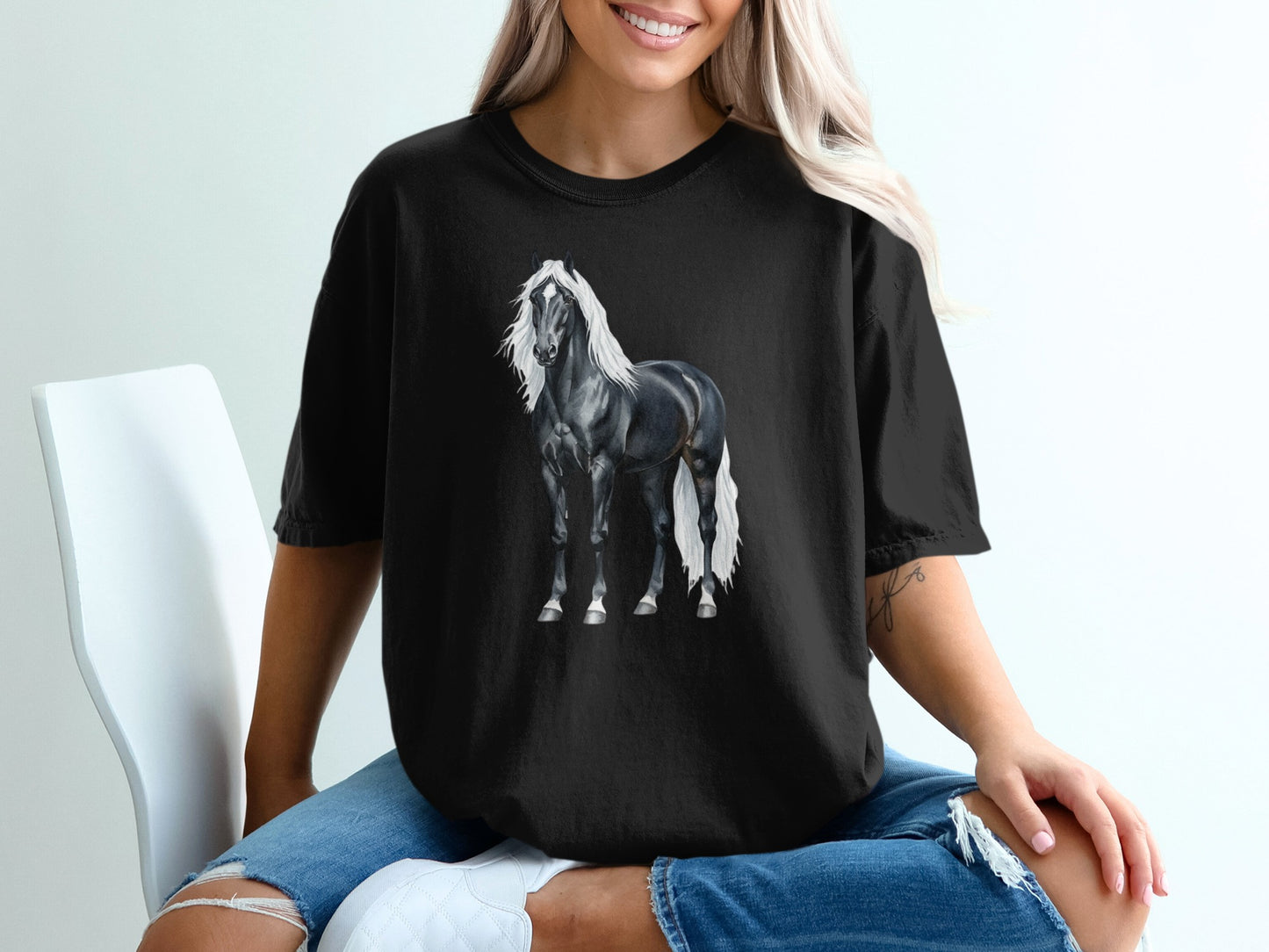 Black horse with white mane and tail on a black t-shirt.