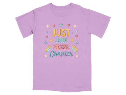 Purple t-shirt with "Just One More Chapter" in colorful lettering and stars.