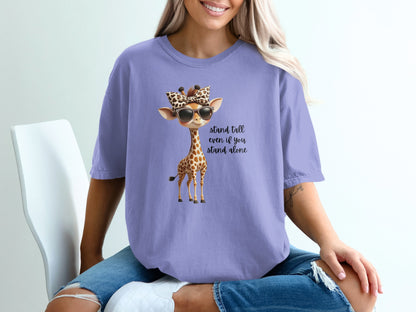 Giraffe wearing sunglasses and a leopard print bow on lavender t-shirt.