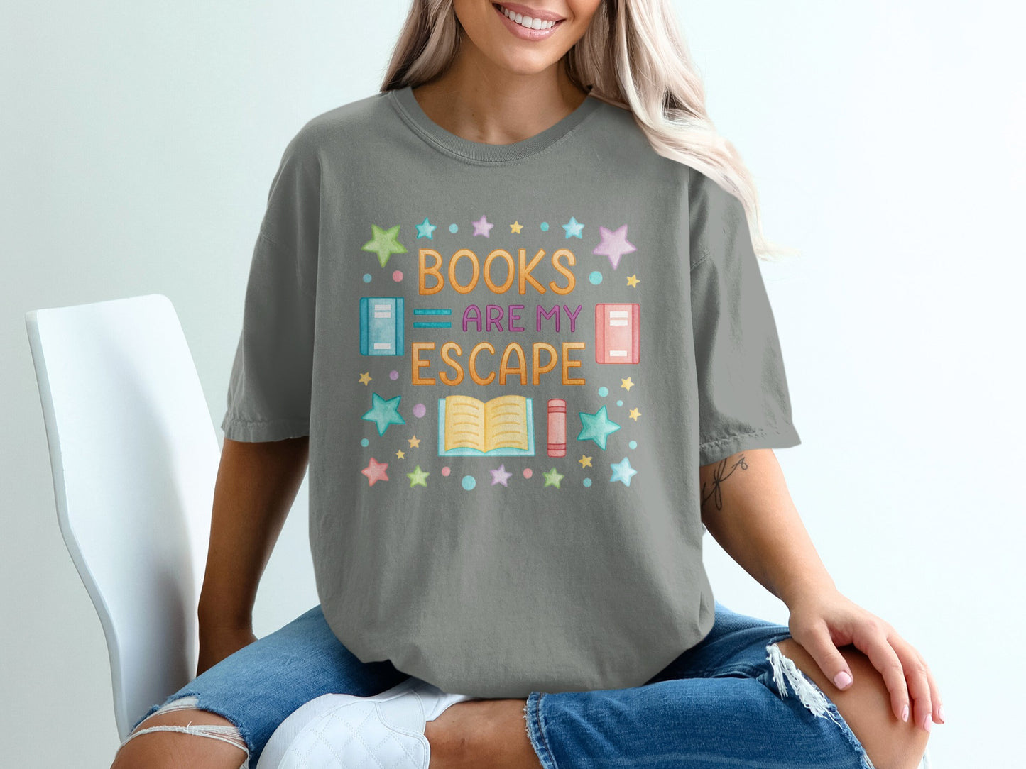 Gray t-shirt with "BOOKS ARE MY ESCAPE" text and colorful stars.