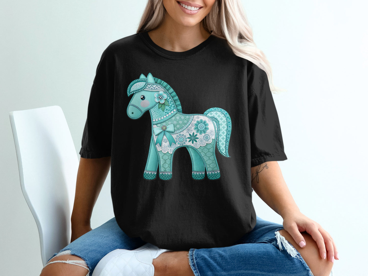 Black t-shirt with a light blue lace-trimmed horse graphic.