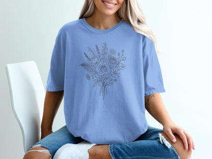 Light blue t-shirt with a line-art floral bouquet graphic on the chest.